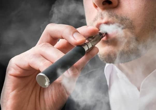 Stock image of a person using an e-cig