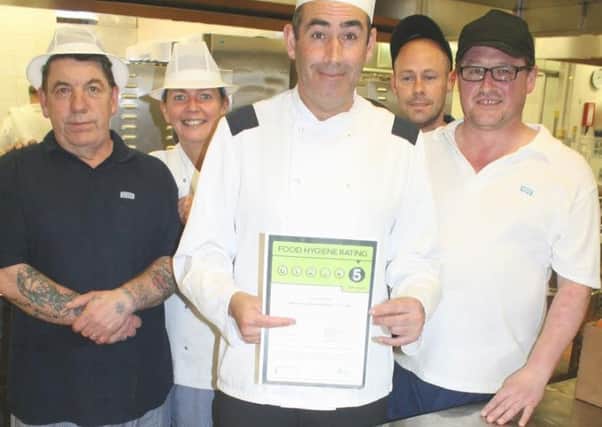 Catering staff celebrate with their five-star food hygiene award