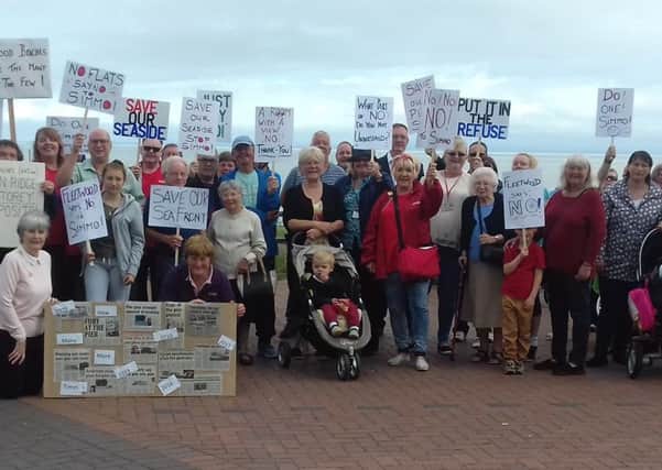A huge crowd staged a silent protest against plans to build flat on the former Fleetwod Pier site.