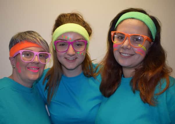 Get your neon on! Fundraising team members Vicki Costigan, Emma Padgett and Antonia Hawkins try the glow in the dark make-up and accessories for the Trinity Hospice Illumathon