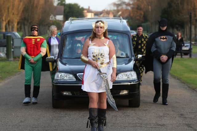 Co-op Funeralcare employee Cindi Gordon leading a superhero-themed funeral cortege