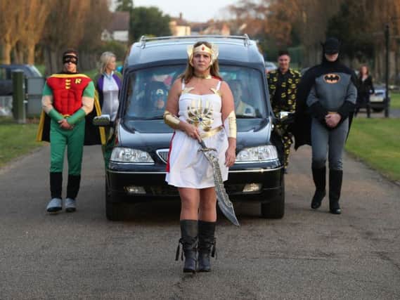 Co-op Funeralcare employee Cindi Gordon leading a superhero-themed funeral cortege