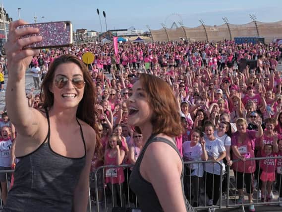Wedding Singer stars Cassie Compton and Lucie Jones take a selfie onstage before the race starts