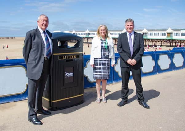 Coun David Eaves, chairman of Fylde Council's operational management committee, Tracy Morrison, Fylde Council's director of resources at and Steve Fletcher, customer support manager for Glasdon UK with an example of a new bigger bin on St Annes seafront