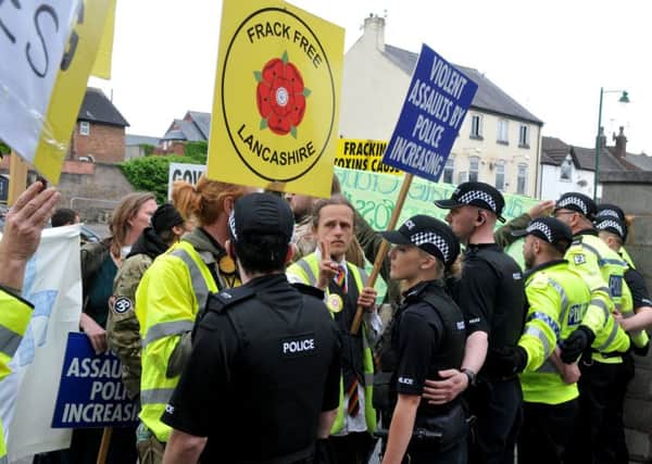 Police hold back protesters outside Kirkham Police Station during one demo