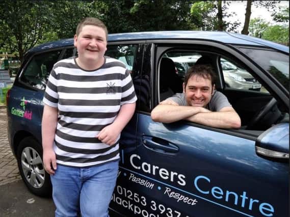 Liam Quinn and Andy Brown, of Play Expo, with the car bought for Blackpool Carers' Centre by charity Games Aid