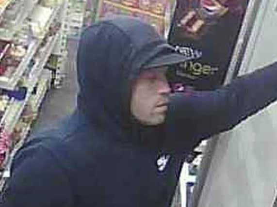 CCTV of a man police would like to speak to about a raid on a McColls store