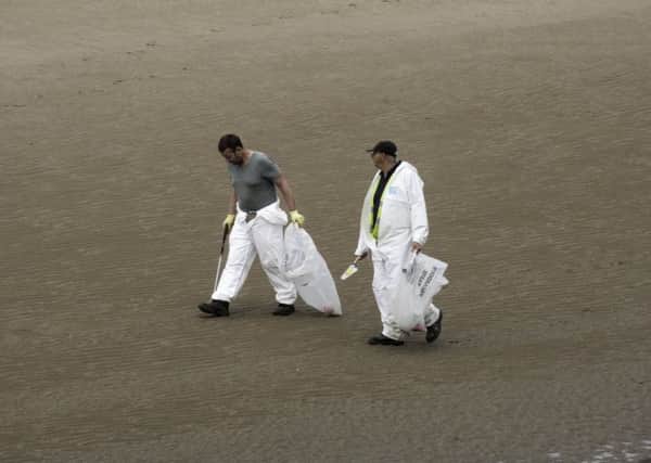 Cleaners at Bispham beach - the day before it's named as one of the best for pets