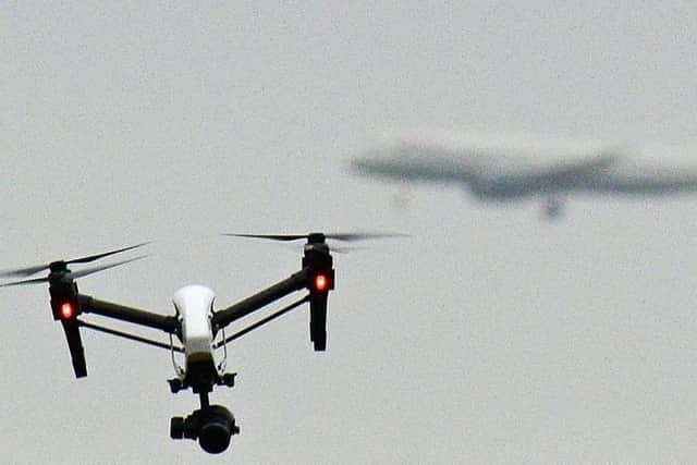 A drone flying in Hanworth Park in west London, as a British Airways 747 plane prepares to land at Heathrow Airport behind (Pic: John Stillwell/PA Wire)