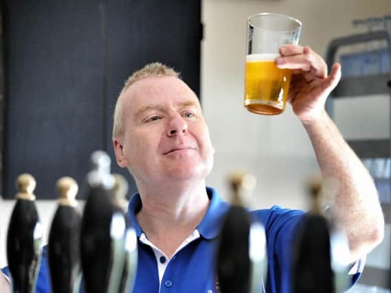Billy Shedden checks one of the beers Pics: JULIAN BROWN