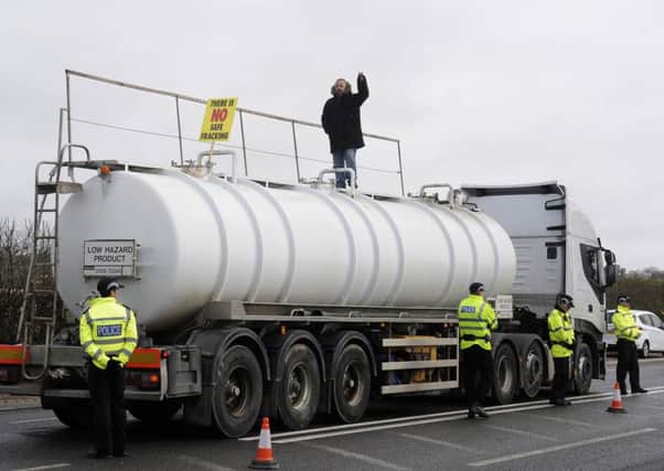 A fracking protester climbs aboard a tanker on Preston New Road