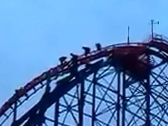 A still from a video showing the teenagers climbing down the Big One roller coaster