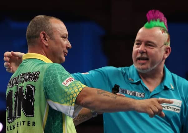 Peter Wright and Darren Webster embrace at the end of their quarter-final 	Picture: Lawrence Lustig/PDC