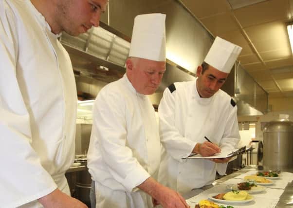 Lee Hammond, Dave Porter and Kitchen Manager Darren Cadwell prepare food in the kitchen at Blackpool Victoria Hospital