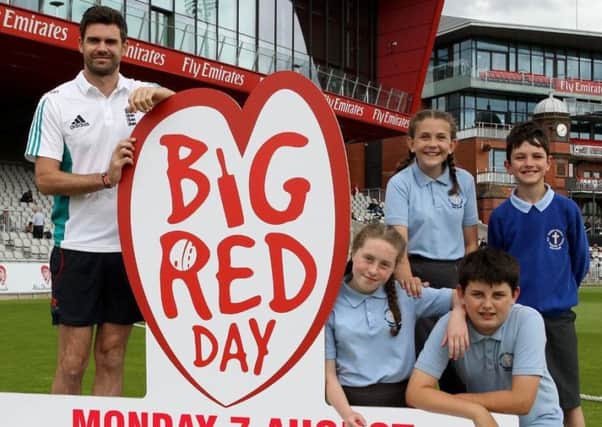 Englands Jimmy Anderson with youngsters launching Big Red Day