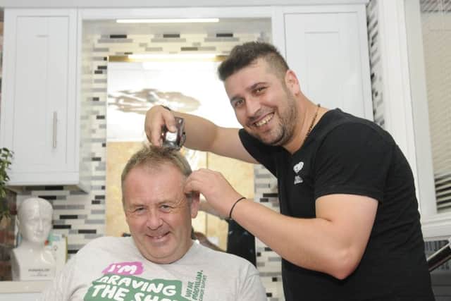 Charity headshave and official opening of The Anti Ageing Institute.  Pictured having his head shaved is Adrian Courtney-Massey with Dara Najin.