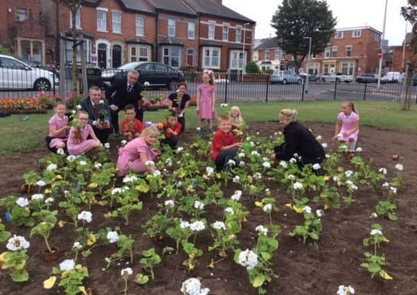 Children from St John's Primary School with ward councillors Mark Smith and Ian Coleman at the garden near the Salvation Army