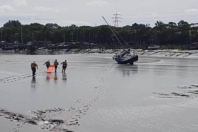 A woman was rescued from a boat after it ran aground near Skippool Creek