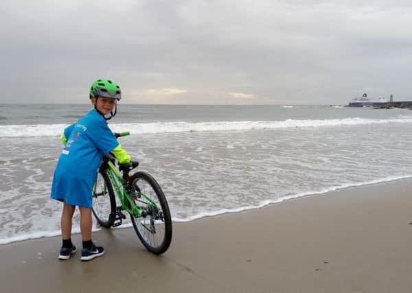 Kodi brought the ride to an end by dipping his bike wheel in the North Sea, while wearing his Brian House t-shirt