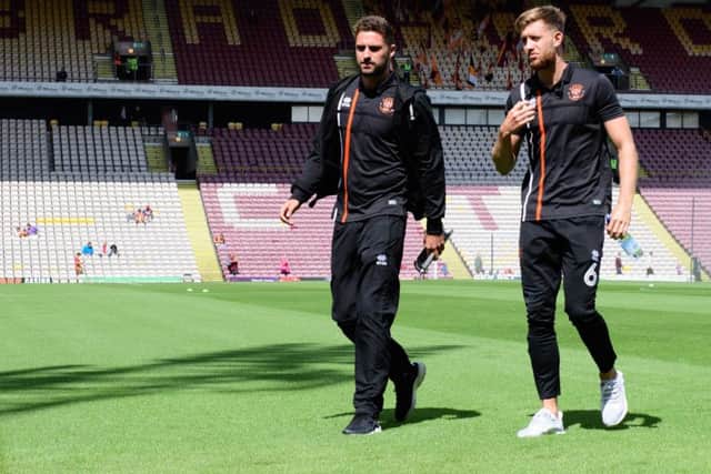 Clark Robertson gets a feel for the Bradford City pitch with fellow defender Will Aimson last weekend