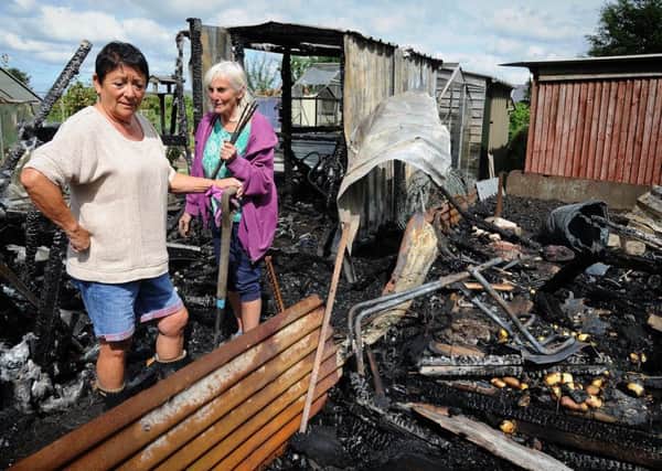 Police were today investigating an arson and theft attack on the Fleetwood Road allotments in Wesham.
Allotment holders Maria Wright (left) and Jean sift through the burnt-out wreckage of three sheds.  PIC BY ROB LOCK
10-8-2017
