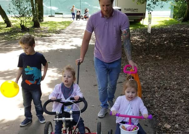 Esme on her trike with little sister Freya and dad Craig