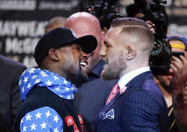 Boxer Floyd Mayweather Jr., left, and mixed martial arts fighter Conor McGregor
