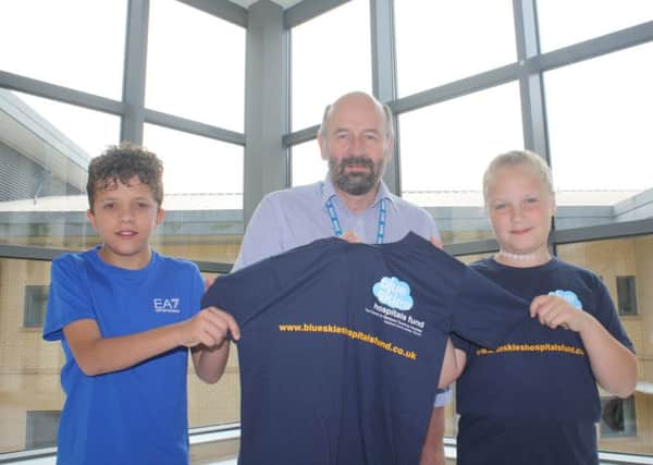 Brayden and Libby Camm with consultant cardiologist Andrew Duncan.