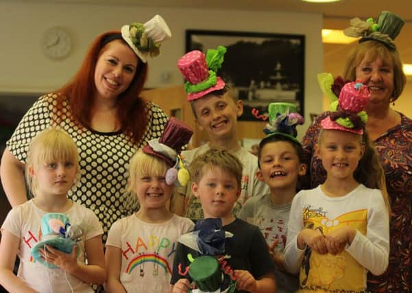 Sophie Tyler (far left) and Christine Lamb with youngsters and their hats.