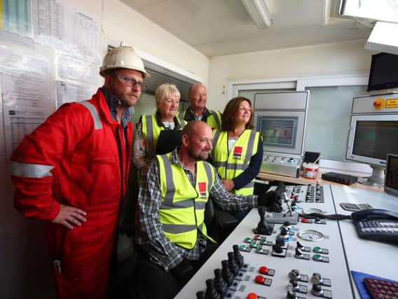 Preston New Road site land owners, Rosalyn, left, Andrew, Pam and Allan (seated) Wensley start the drilling rig, with Cuadrilla driller Thorsten Strathmann
