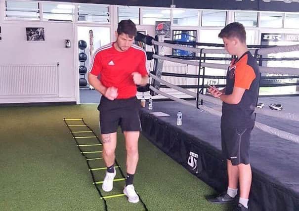 Harry Gayton, 16, has started his work placement with Blackpool FC
Community Trust Ambassador Brian Rose at his local boxing gym.