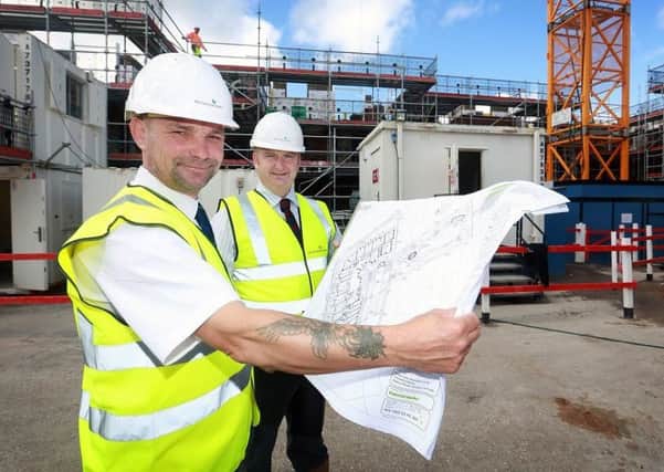 McCarthy & Stone assistant site manager Simon Leakey and Coun Alf Clempson looking over the plans for the new development on Station Road, Poulton