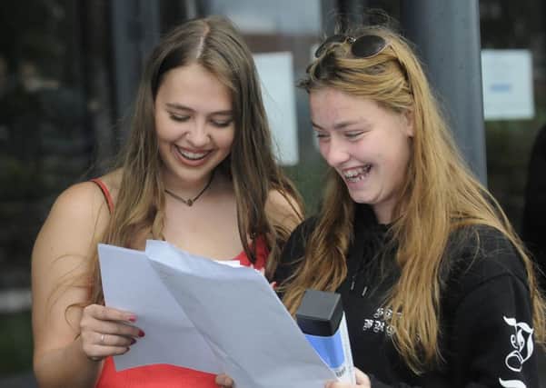 Highfield Academy pupils collect their GCSE results.  Keeley Smith and Laura Mason compare results.