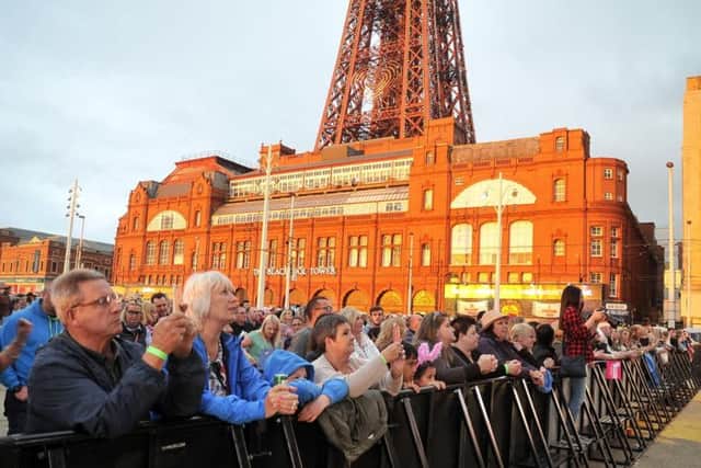 The late evening sunshine casts a glow over fans waiting to see musical legends The Jacksons at Livewire Festival in Blackpool