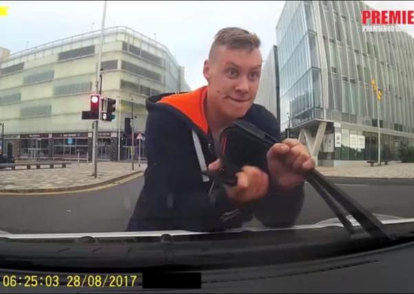 A furious cyclist rips off a taxi's windscreen wiper after falling off his bike on Cookson Street, Blackpool. Picture taken from a video by Premier Taxis Lytham St Annes & Blackpool