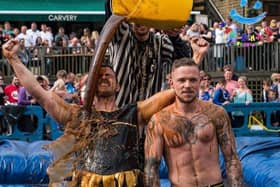 Trevor, left, is covered in gravy as he is announced winner of the 10th World Gravy Wrestling Championships