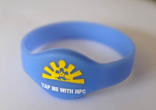 The Â£5 wristband is being handed out to people with dementia so their families can be contacted in crises easily