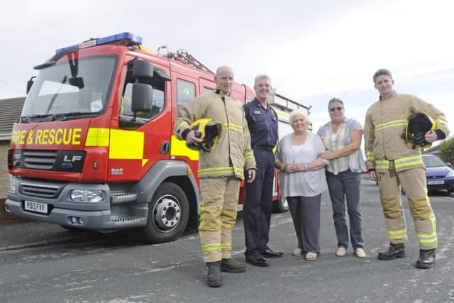 Ann Walker meets the firefighters who came to her aid and were able to contact her daughter, Jane Davies, thanks to a NFC bracelet from The Good Deeds Trust.  They are pictured with firefighters Michael Clueit, Patrick Thompson and Chris Moreton.