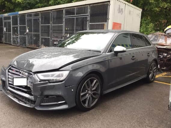 Police handout photo of the damaged grey Audi police car that was rammed by a white Ford Transit van following a high-speed chase in Salford