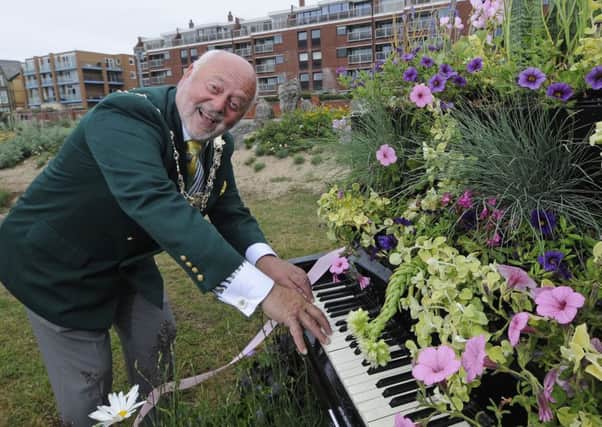 Fylde mayor Coun John Singleton gives the piano display a go at the opening of the new-look peace and happiness garden in St Annes