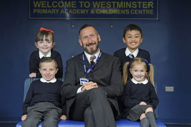 Clockwise from top left is Makayla Collier, nine, Michael Hill, eight, Macie Davies, four, headteacher Roger Farley and Thomas Mitchell, six.