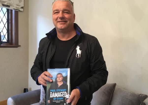 Paul Stewart with his book Damaged