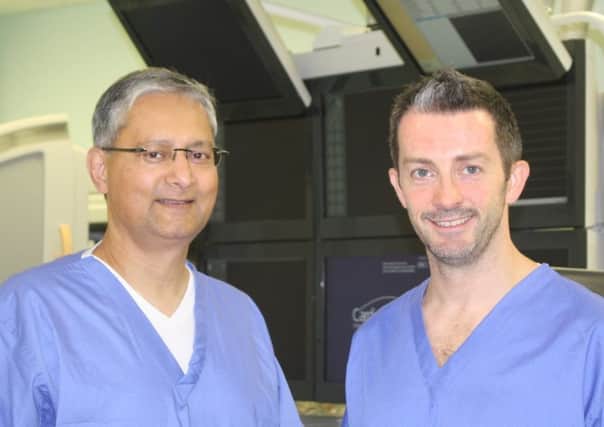 Dr Sanjay Deshpande, left, visited Dr Scott Gall all the way from America to see him carry out pioneering heart surgery