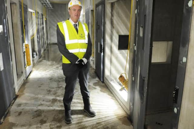 Lancashire's Police and Crime Commissioner Clive Grunshaw inspects the cells at Blackpool's new police station in Marton