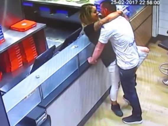 CCTV footage shows the couple romping in Domino's