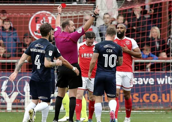 Fleetwood Town's Aiden O'Neill is shown a red card