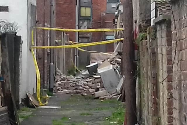 Debris from the blast was strewn across the alley at the back of the property