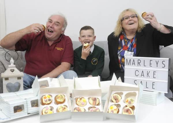 Seven-year-old Marley Johnson is selling cupcakes to raise money for Poulton and Wyre Railway.  He is pictured with Peter Williams from Poulton and Wyre Railway and Coun Norah Stuchfield.