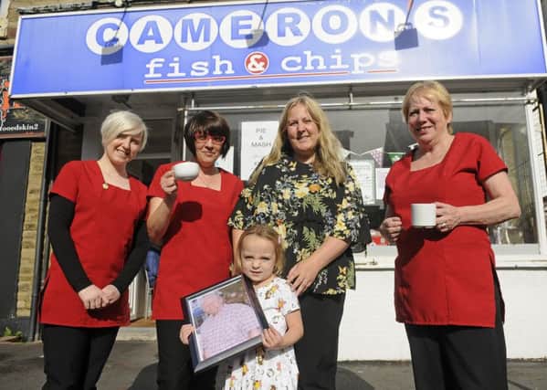 Macmillan Coffee Morning at Cameron's Chippy on Highfield Road.  Pictured are Shelby Mercer, Philippa Smith, Deena Holden, Lily Holden with a picture of John Cameron McGill and Ann McGill.