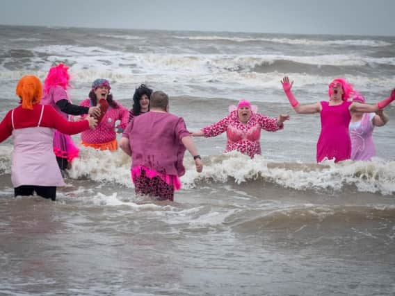 Annual pink dip for Cancer Research - volunteers jumping into the sea at Blackpool for charity.